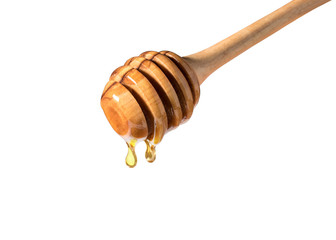 Honey dripping from honey dipper on white background. Thick honey dipping from the wooden honey spoon. Healthy food concept.