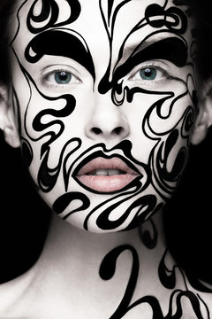 Beautiful girl with art black and white makeup and nails. Creative beauty face. Photo taken in the studio.