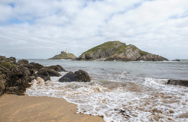Fototapeta na wymiar Landscape image of Mumbles lighthouse taken from the beach 