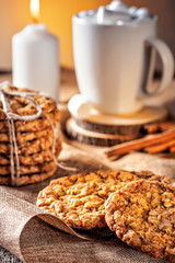 Winter autumn still life  homemade recipe honey ginger oatmeal cookie and bagel, cocoa cup coffee with marshmallow on wooden table kitchen