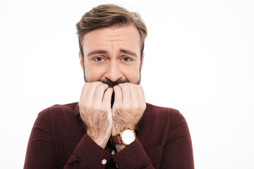 Close up portrait of a frightened young bearded man