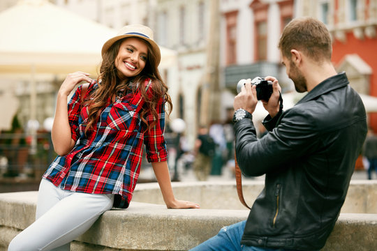 Couple In Love. Man Taking Photos Of Beautiful Woman In Street.