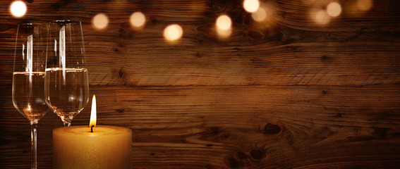 Rustic background with candle and champagne