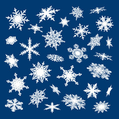 Set of white snowflakes on blue background