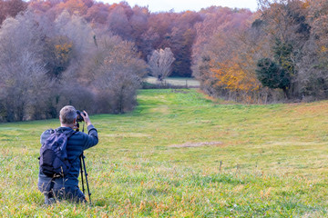 Photographer take pictures  of beech forest near town Olot in Spain, La Fageda
