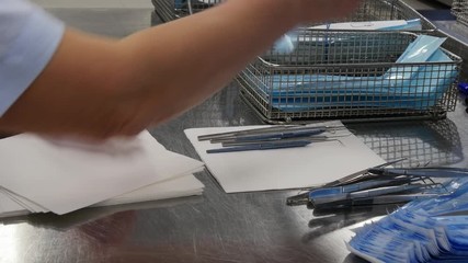 Hands of women and medical instruments. Set sterile tools. Professional work of surgeon doctor. - Powered by Adobe