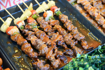 Steak barbecues cooking grilling in street market in thailand,Barbecue grill with various kinds of meat, Soft focus