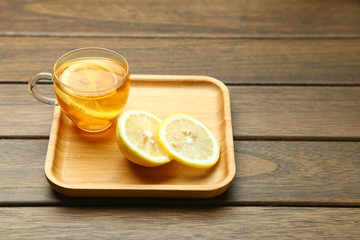 lemon black tea in glass cup on wooden table