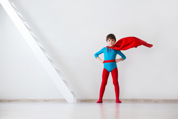 Success. Boy super hero in a red cloak.