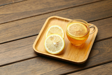lemon black tea in glass cup on wooden table