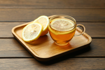 lemon black tea in glass cup on wooden table