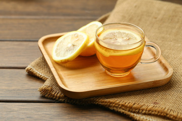 lemon black tea in glass cup on wooden table