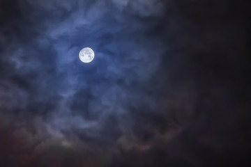 Naklejka na ściany i meble Full moon on a cloudy night sky