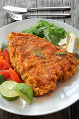 white fish steak with salad and cheese