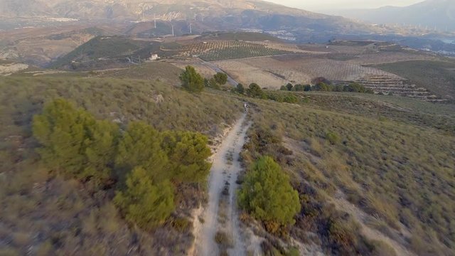 Dirt Biker Travelling Fast Across Barron Landscape