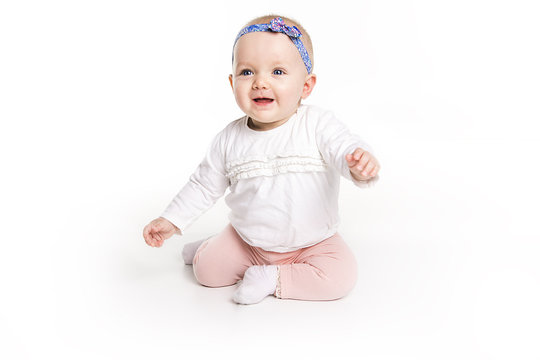 six month old baby, in front of a white background