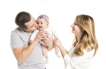 Young father, mother holding cute baby girl over white background
