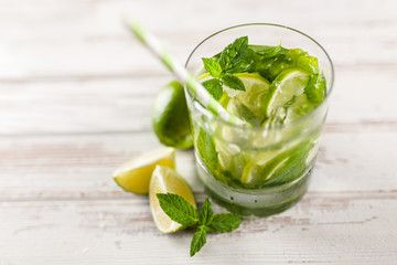 Mojito cocktail on white wood background