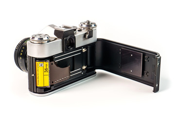 Retro film photo camera isolated on white background. Old analog camera back door and photo film isolated on white background. Vintage design.
