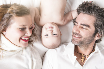 young family with baby on bed. View from above