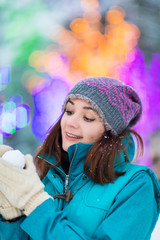 Happy winter women in park snow Christmas lights
