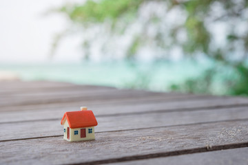 Miniature house on wooden background.Image for property real estate investment concept.