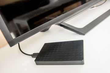 The hard disk connected to the TV. The mobile backup device is connected to a TV cable. Download...