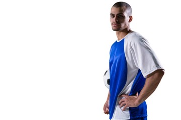 Portrait of football player holding a football