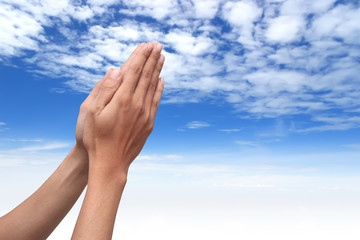 hand praying with sky background