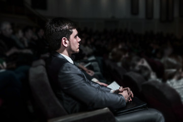 successful businessman sitting on a business conference in the modern conference hall