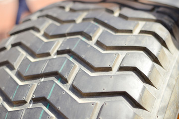 Close-up detail of car tires. Macro photography textured transportation pattern concept, abstract...