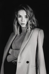 Black and white portrait of young attractive pretty blonde woman in the  jacket, leather shirt,...