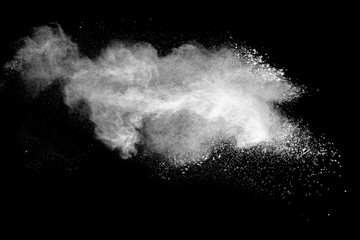 Launched white powder splash on black background.