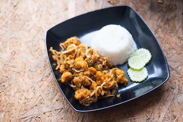 Spicy salad with fried chicken with rice