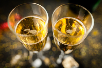 Two champagne glasses in golden glitter
