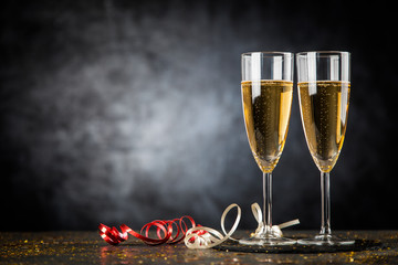 Two champagne glasses in golden glitter
