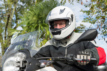 portrait of a senior biker on his motorcycle