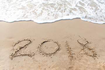 Written 2018 on the sand of a beach for happy new year.  Travel Concept