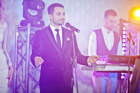Musicial music live band performing on a stage with different lights.