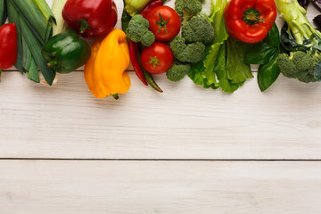 Border of fresh vegetables on wooden background with copy space