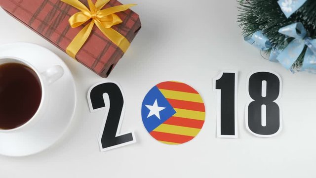 Illustration, new year, male hand put on the table an Catalonia flag, cauntry ball, 2018
