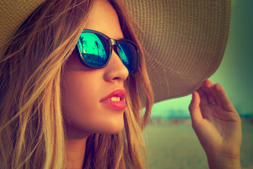 Blond teen girl sunglasses and pamela sun hat