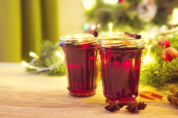 Christmas hot mulled wine with cinnamon cardamom and anise on wooden background