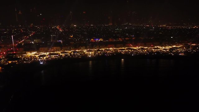 Fantastic nighttime skyline with illuminated skyscrapers. Elevated view of downtown Dubai, UAE. Colourful travel background. Beautiful view of the Dubai night with lanterns, the river and nightlife