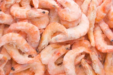 Gordijnen Frozen shrimps in ice. A lot of royal shrimp close-up. © eremin