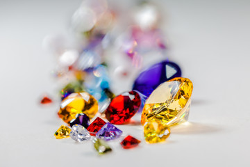 colorful gemstones are displayed on the white floor