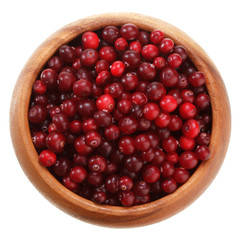 cranberries in a wooden bowl isolated on white background