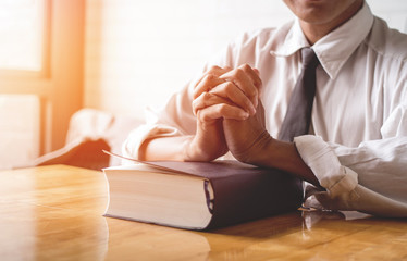 close up, the pastor laid hands on the black book of the Bible, Buddhist, Catholic, Christian,...