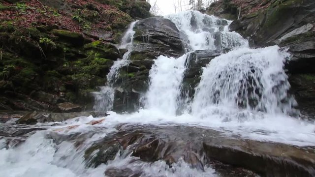 Rush water of waterfall in Carpathian mountains with low angle above the water (1080p, 25fps, sound)