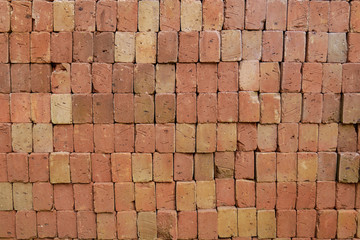 Stack and heap of red bricks background, red brick raw construction material